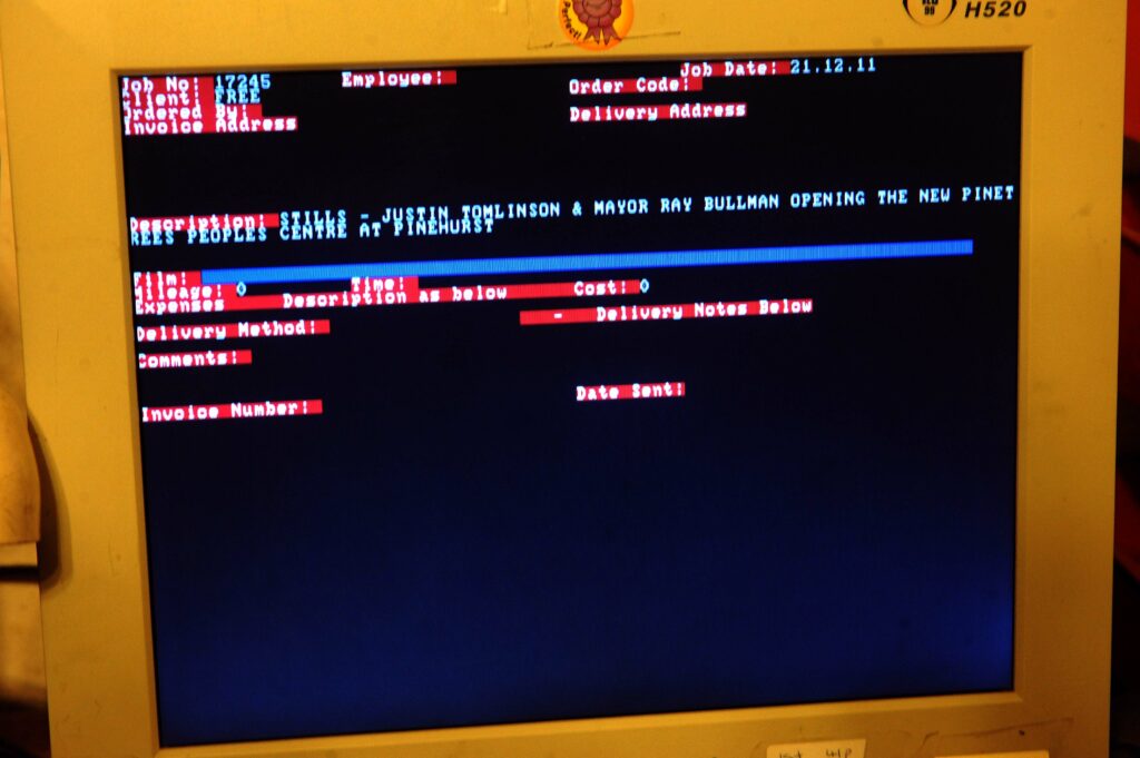 An old CRT computer monitor shows the text-based database that I built called "Job Sheet Manager"
